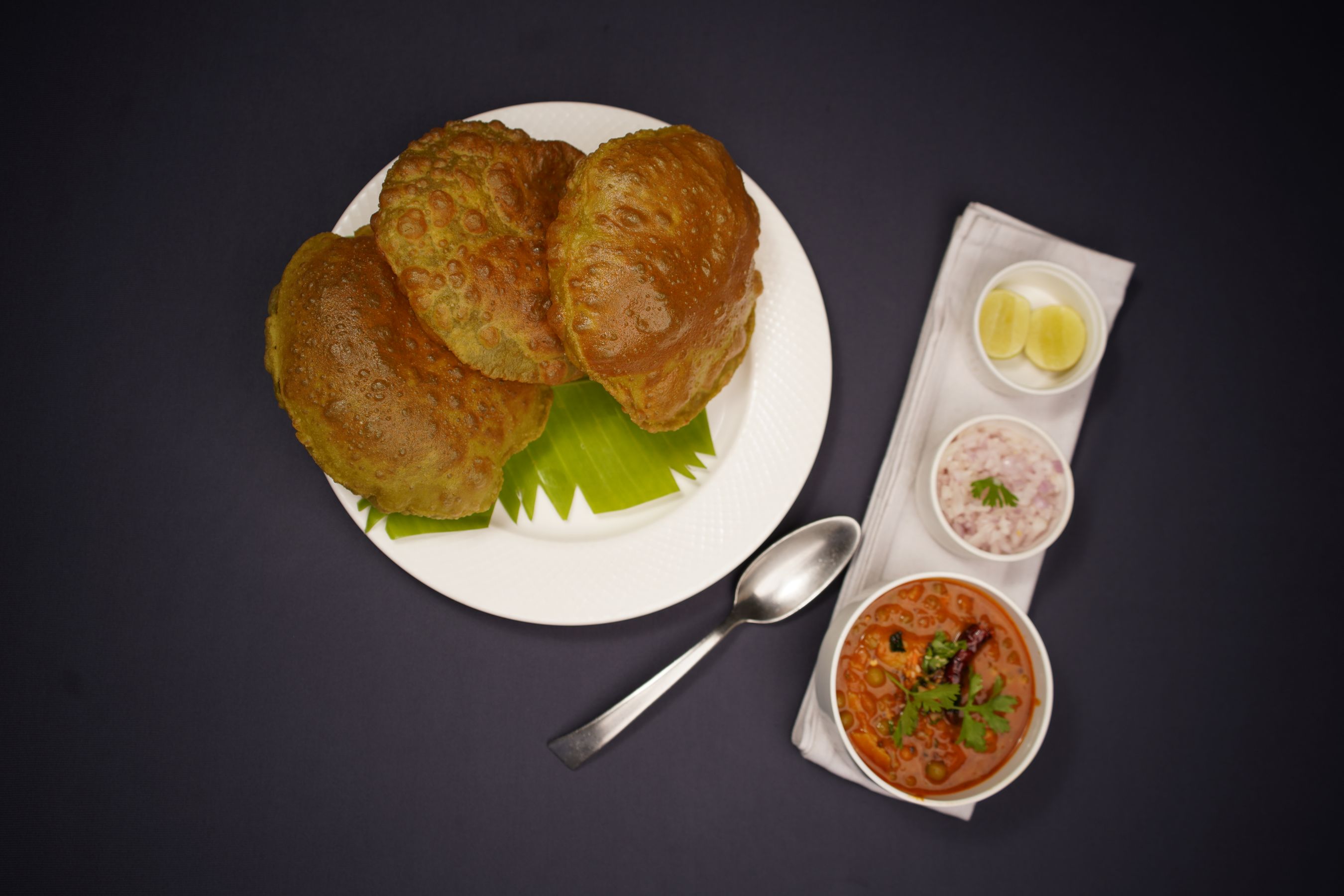 Chole bhature plate with pickle and onion